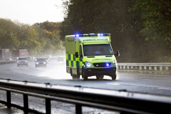 Ambulance with blue lights on driving to incident