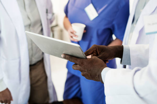 Doctors discussing with clipboard