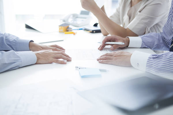 Three people examining documents