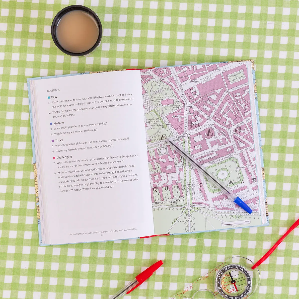 OS puzzle book, Legends and Landmarks, open on a page with a map and a series of questions from easy to challenging.